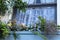 Window by the sea - Looking up at a window with lace nautical curtians in wooden house with window box planter with flowers