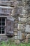 Window and stone chimney on wood cabin exterior wall