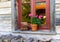 Window of typical austrian farmhouse decorated with geranium flowers