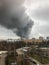 Window view of a huge column of smoke over the city.