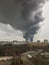 Window view of a huge column of smoke over the city.