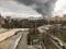 Window view of a huge column of smoke over the city.