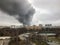 Window view of a huge column of smoke over the city.