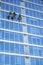 Window washers wash windows of high-rise buildings falling and rising like mountaineers on fixed ropes