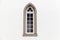 Window in white stone wall, Gothic Revival