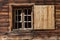 Window of a wooden alpine hut. Rustic background