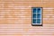 Window on wooden weatherboard wall.