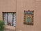 Window with wrought iron design and religious carving, Chimayo, New Mexico