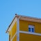 Window on the yellow building facade in Bilbao city