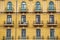Window on the yellow building facade in Bilbao city