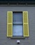 Window with yellow shutters