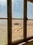 Windows in building dirty in dust. Abandoned in ghost town Kolmanskop in desert.