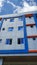 Windows of Building with Sky and Clouds Backdrop