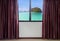 Windows with curtains and blinds looking out the window frame meet tropical seaside view