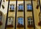 Windows decorated with geranium flowers on a block of flats