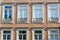 Windows decorated with traditional ornate Portuguese decorative color tiles azulejos in orange brown hue