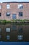 Windows and door on the side of an old, industrial, red brick building alongside the Birmingham canal
