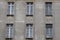 Windows on the facade of the ragged old gray house