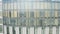 Windows of high-rise building on background city. Stock footage. Top view of panoramic Windows of skyscraper on