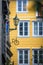 Windows of an old yellow house in the Bergen old town