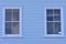 Windows on pale blue wall