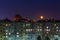 Windows, roofs and facade of an mass apartment buildings in Russia at full moon night.