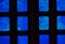 Windows of a room the light is playing through the blue glass of the window