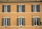 Windows and shutters of ancient Rome, old buildings facade