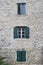 Windows with shutters in the three storey building