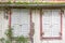 Windows with window shutters of an decayed house