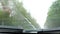 Windshield in the car at speed in the rain, the view from the passenger compartment on the road in motion, rain