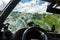 Windshield view from the interior of a car through a window covered with a layer of dried swamp.