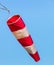 A windsock at an airport against blue sky