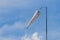 Windsock blowing against lightly cloudy sky - Room for text