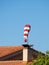 Windsock floating horizontally above a house