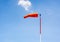 Windsock on pole against blue sky