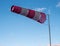 Windsock during a strong wind. Windsock shows wind direction and strength. Made of fabric in the form of a cone. It is