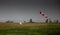 Windsock, weather vane for airfields. Red and white striped fabric showing wind speed, strength and direction. Umbrella cap at the