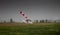 Windsock, weather vane for airfields. Red and white striped fabric showing wind speed, strength and direction. Umbrella cap at the