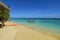 Windsurf and Speedboat on a sandy beach