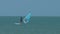Windsurfer beginner sails keeps balance at ocean