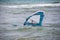 windsurfer with a board on a tropical beach, makes water start