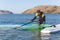 Windsurfer checking his sail and board equipment