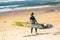 Windsurfer holding the sailboard ready to start her training