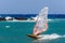 Windsurfer making extreme tricks on a flat water at Santorini island