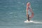 Windsurfer sailing in the sea.