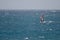 Windsurfer sailing in the sea.