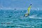 Windsurfer Surfing The Wind On Waves In Garda Lake, Recreational Water Sports, Extreme Sport Action. Recreational Sporting