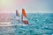 Windsurfer Surfing The Wind On Waves In Garda Lake, Recreational Water Sports, Extreme Sport Action. Recreational Sporting