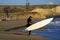 Windsurfer walking on the beach.